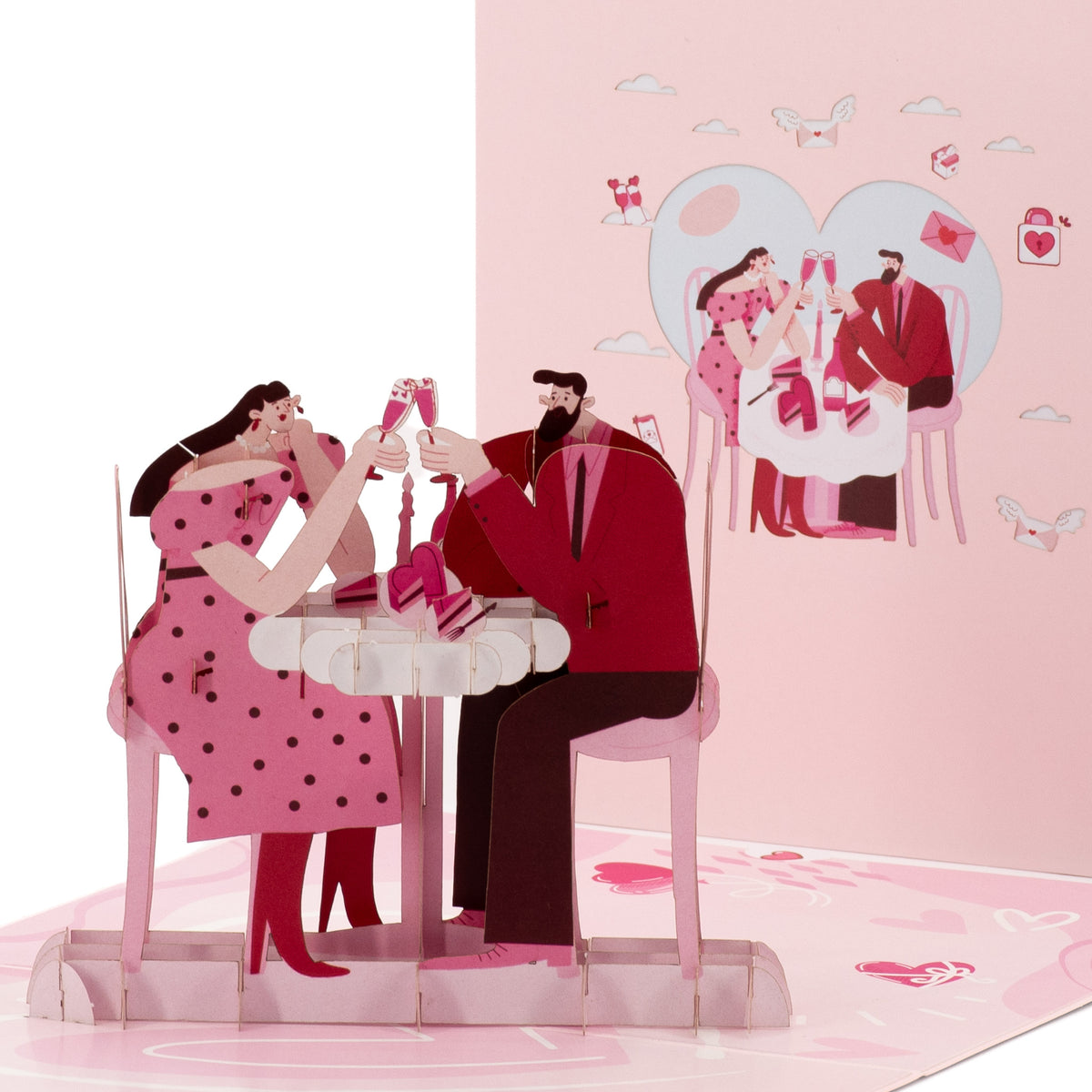 A Toast to Us 3D pop-up card close-up: paper couple in red clinking glasses over a cake at their table, everpop