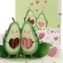 Avocado in Love 3D pop-up card close-up: two smiling avocados with heart pits and love stickers, everpop