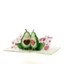Avocado in Love 3D pop-up card angle view: avocado pair pop-up with leaves on a love-doodle base, everpop