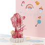 Baby Girl and Balloons 3D pop-up card close-up: sleeping baby in a pink bundle beneath striped balloons, everpop