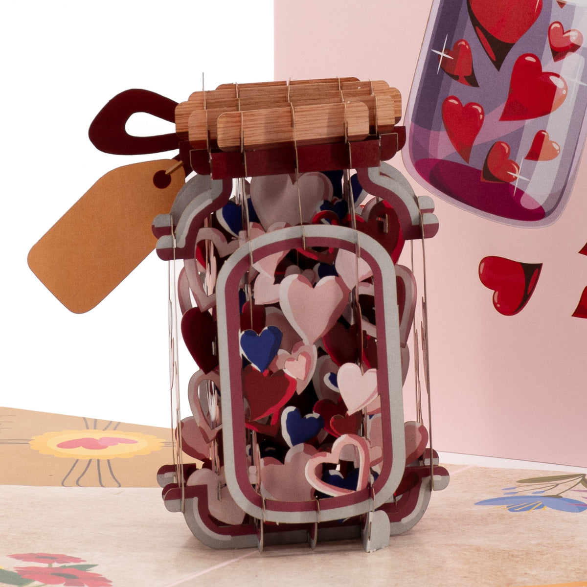 Bottle Full of Wishes 3D pop-up card close-up: heart-filled bottle with woven lid, red bow and gift tag, everpop