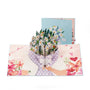 Daisy Days 3D pop-up card front view: daisy bouquet in purple wrapping, blue cover behind, everpop