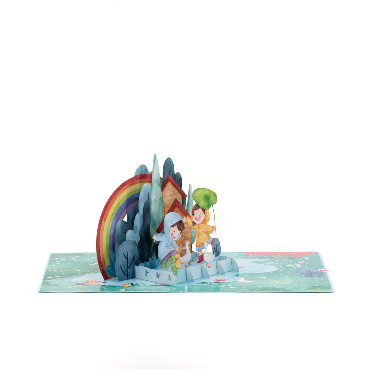Dancing in the Rain 3D pop-up card angle view: rainbow and cottage pop-up over a pond and meadow base, everpop