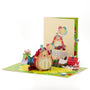 Happy Hedgehog Birthday 3D pop-up card front view: party-hat hedgehog with balloons, cream cover behind, everpop