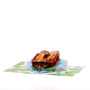 Holding On 3D pop-up card angle view: floating otters pop-up on a lily-pad pond base, everpop