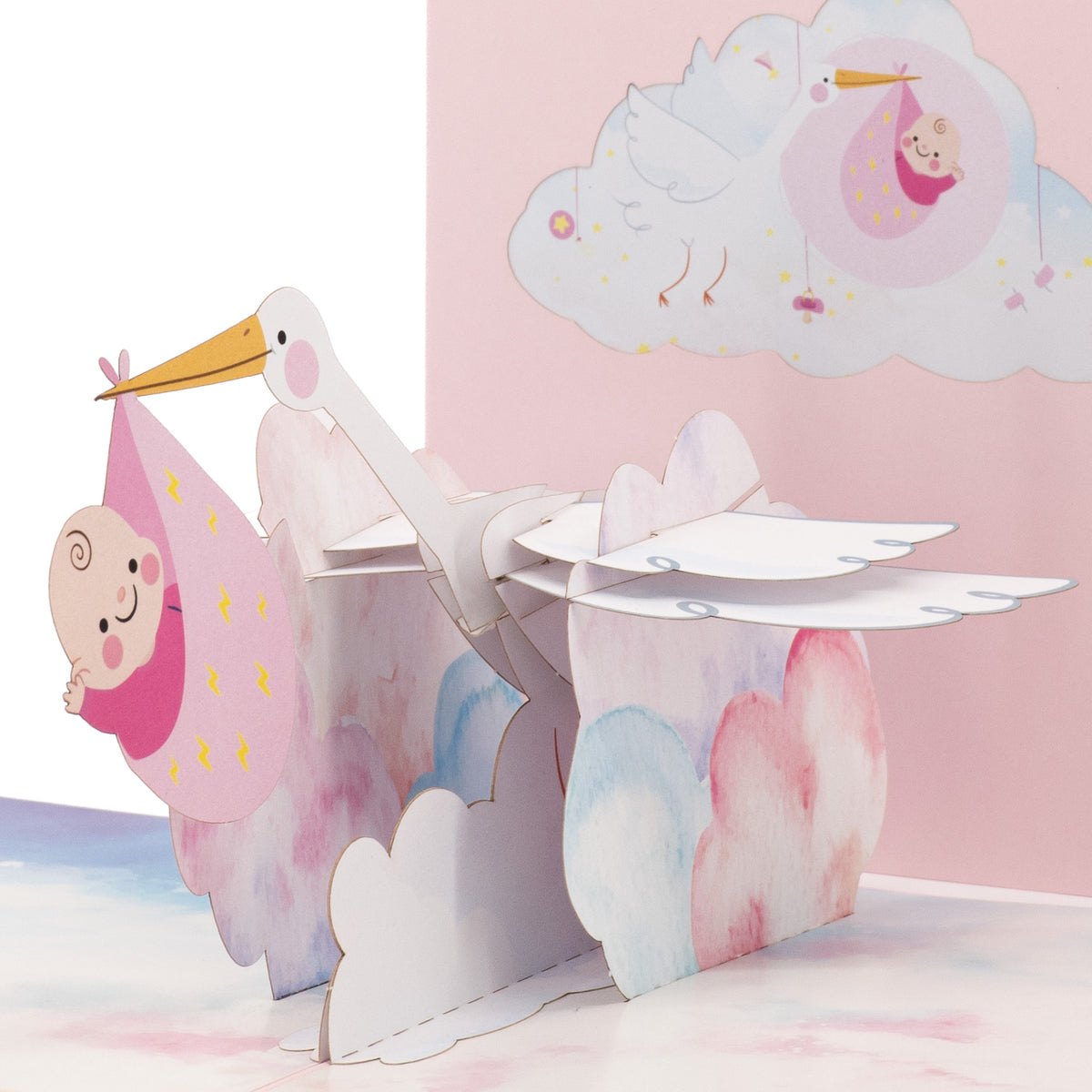 It's a Girl! Stork 3D pop-up card close-up: white stork with baby in a pink bundle over clouds, everpop