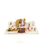 The Treehouse 3D pop-up card angle view: treehouse pop-up with playground wall of playing kids, everpop