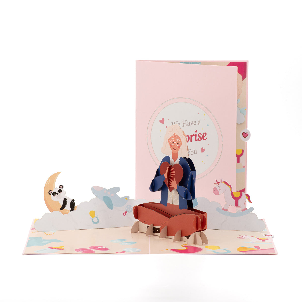 We Have a Surprise 3D pop-up card front view: mum-to-be hugging a red heart, surprise cover behind, everpop