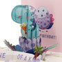 You're One of a Kind Birthday 3D pop-up card close-up: teal dino in a spotted egg over a One of a Kind banner, everpop